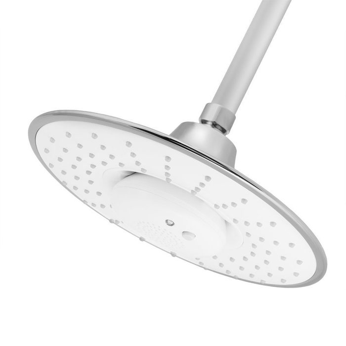 A circular showerhead is suspended from a metal arm, designed to release water through multiple small holes, typically found in bathrooms.