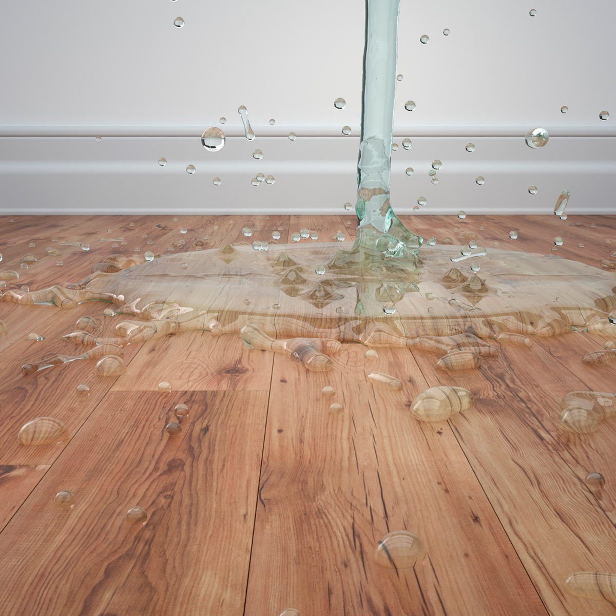 Liquid spills onto a wooden floor, creating bubbles and ripples as it spreads across the surface in a well-lit indoor space.