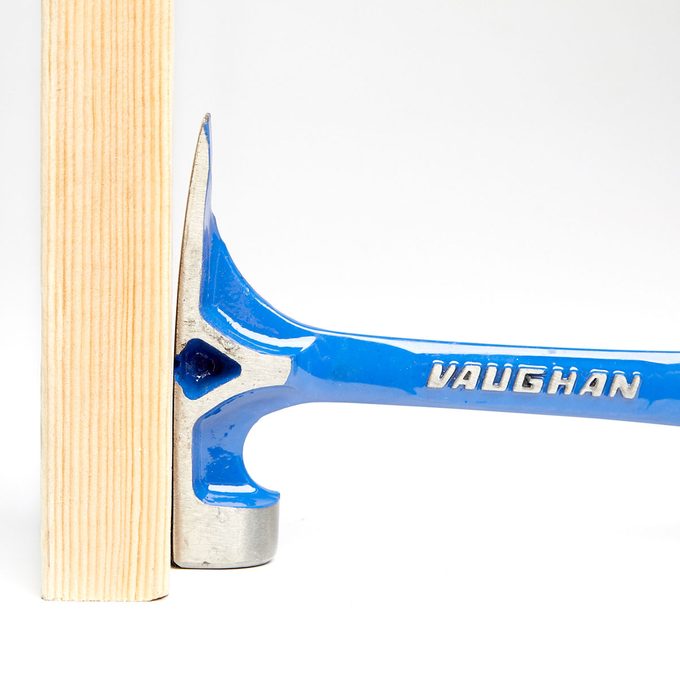 A flat hammer head top pushed against wood| Construction Pro Tips