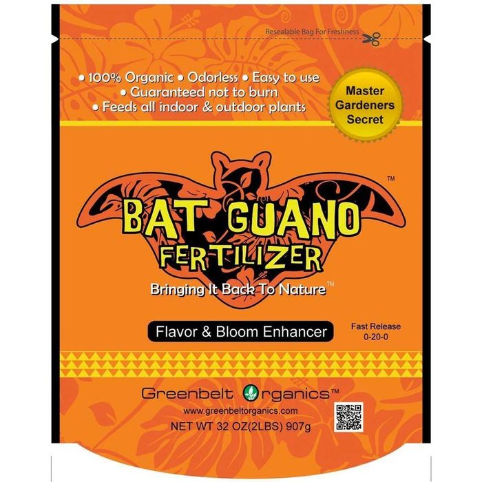 A resealable bag of bat guano fertilizer features an orange background, a bat graphic, and information about its organic, odorless properties for enhancing plant growth.
