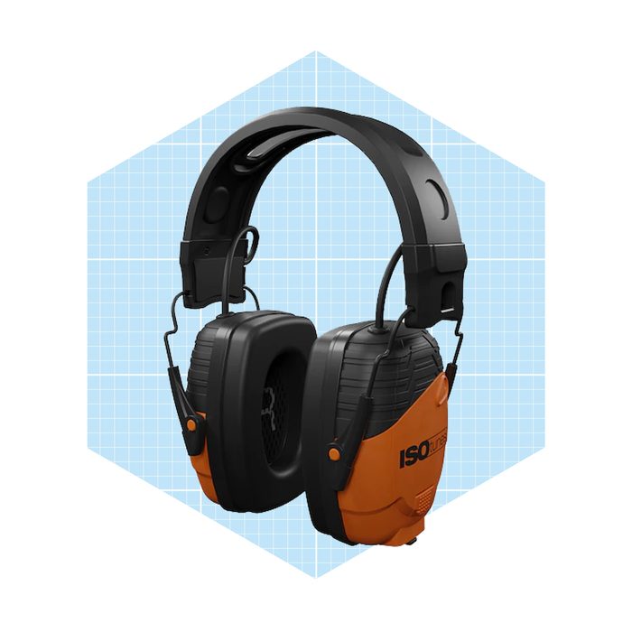 Protective earmuffs rest prominently, designed to reduce noise, set against a light blue grid background, emphasizing their ergonomic structure and bright orange accents.