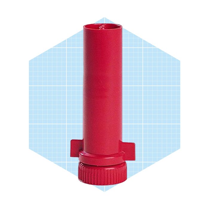 A red cylindrical object stands upright with a textured base and two side attachments, set against a light blue grid background.