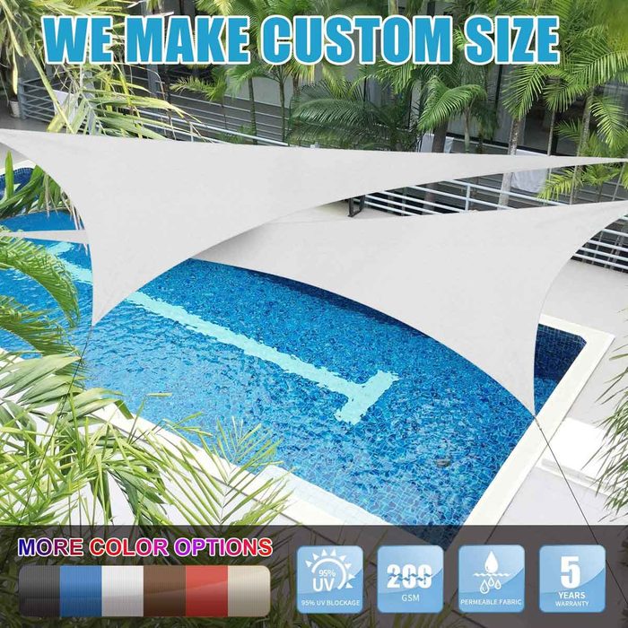 A white shade sail is suspended above a blue swimming pool, surrounded by greenery in a modern outdoor area, promoting custom sizes for shade solutions.