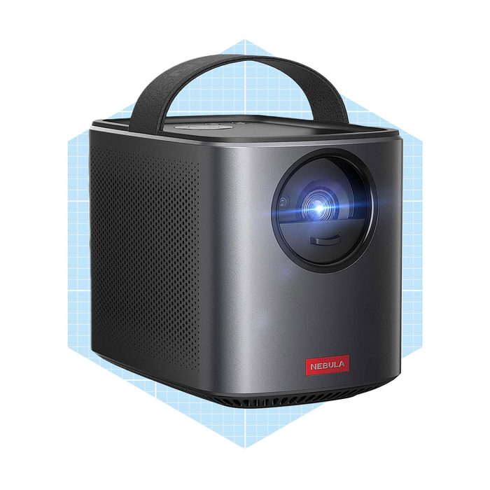 A compact projector projects light from its lens, surrounded by a geometric blue background, designed for portability and viewing convenience.
