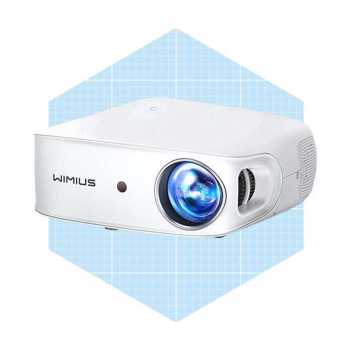 A white projector with a prominent lens projects images, set against a light blue geometric background.