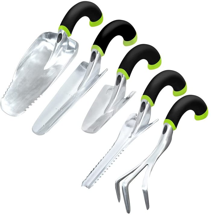 Five gardening tools are lined up, each with a shiny metal head and a black and green ergonomic handle, ready for use in planting or maintenance.