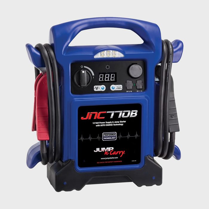A portable jump starter with a blue casing displays various buttons, a digital screen, and attached cables, designed for battery charging in vehicles.