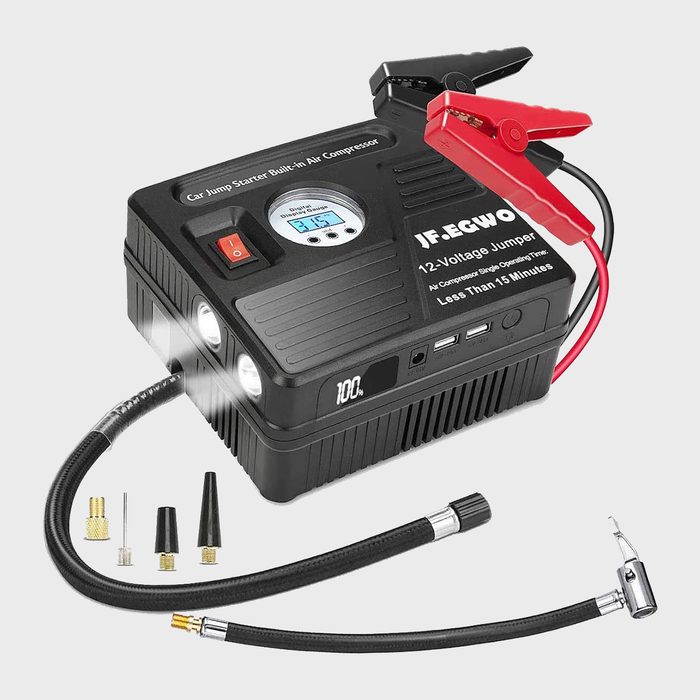 A portable jump starter features clamps, a digital display, and a built-in air compressor, surrounded by various nozzles for different inflating needs.
