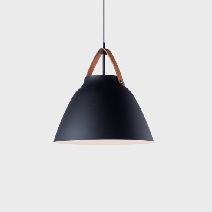 A black pendant lamp hangs by a leather strap, illuminating its surroundings with a warm light against a neutral gray background.