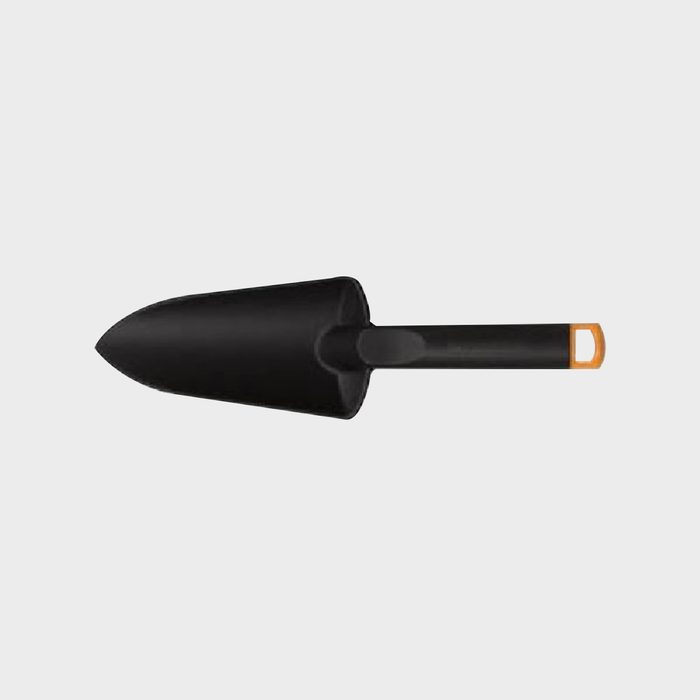 A black gardening trowel rests in a neutral background, designed for digging or planting in soil, with a distinct orange accent on the handle.