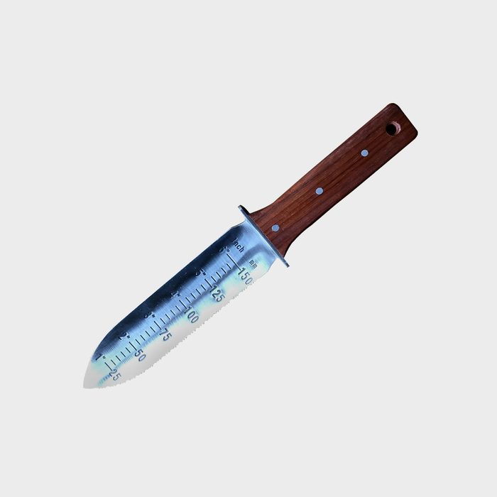 A measuring knife with a serrated edge rests diagonally on a plain white background, featuring a wooden handle and measurement markings along the blade.