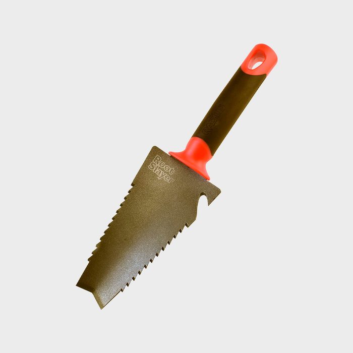 A serrated garden trowel with a bright red handle rests against a neutral background, designed for cutting through roots while digging.
