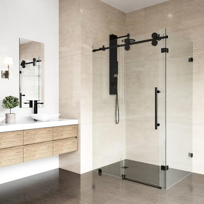 A glass shower enclosure stands in a modern bathroom, featuring a sleek vanity with a basin, a mirror above, and minimalistic decor.