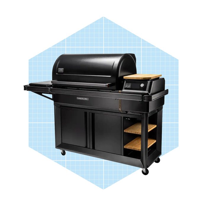 A black outdoor grill sits on wheels, featuring a large lid, side shelving, and digital controls, set against a light blue grid background.