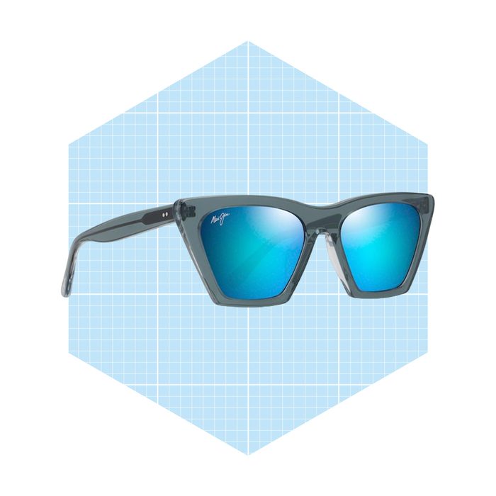 Sunglasses with a geometric frame and blue mirrored lenses are displayed against a light blue grid background, emphasizing their modern design.