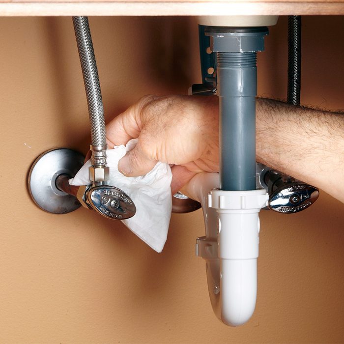 A hand cleaning a sink