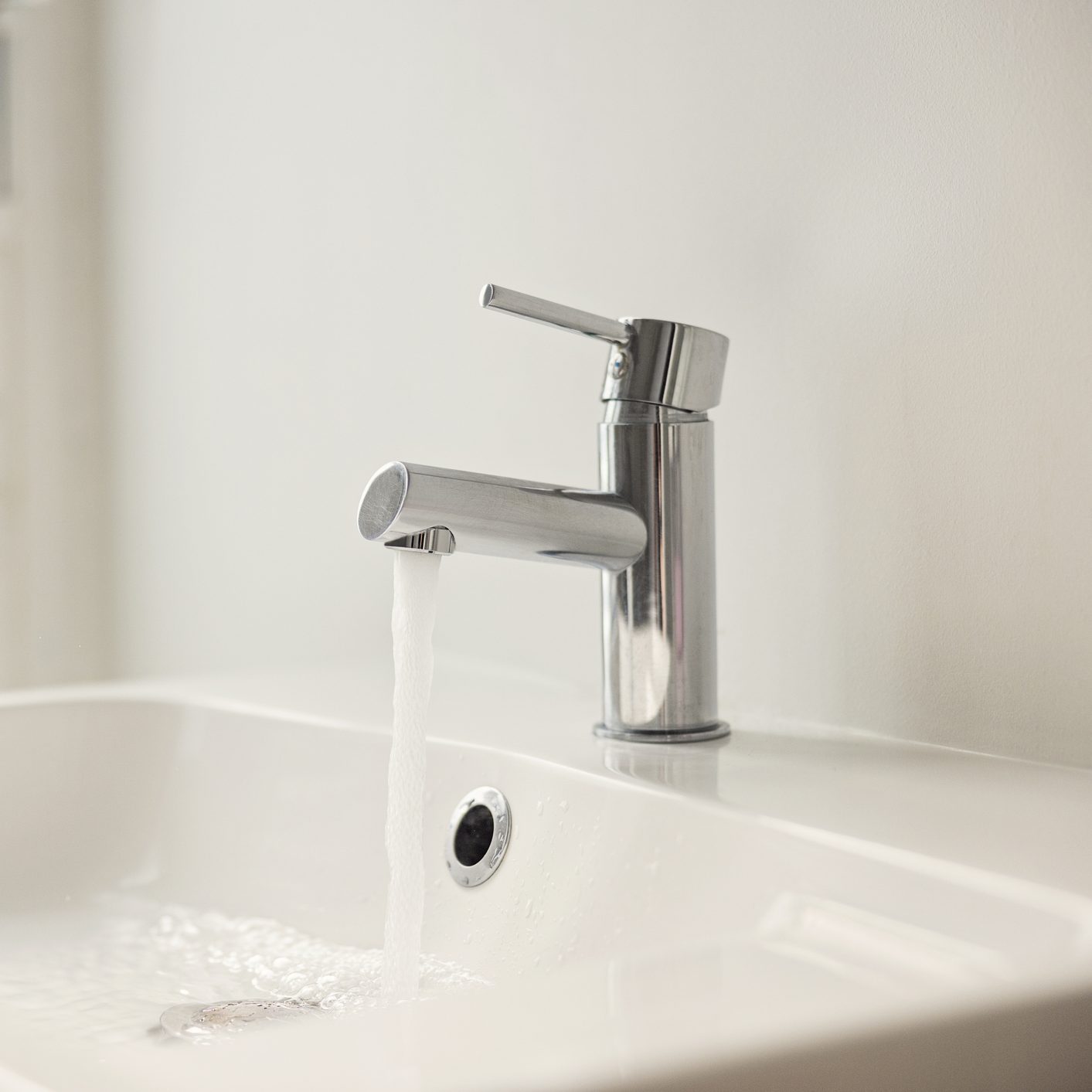 Water pouring from sink faucet
