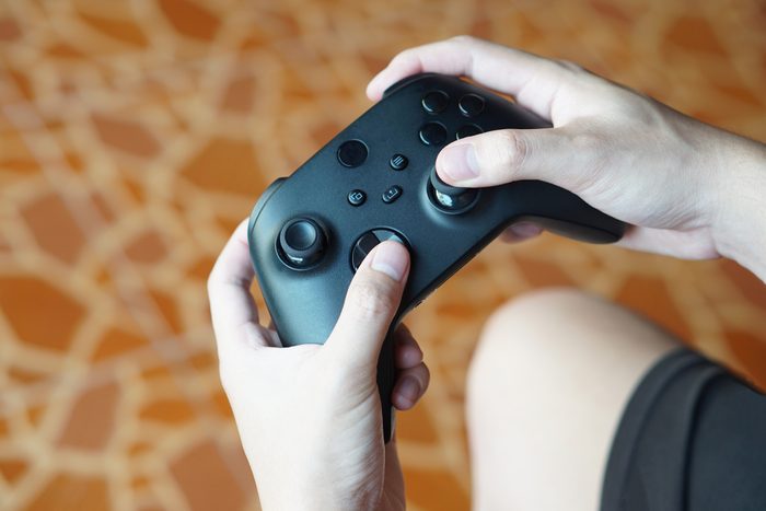 Close up hands hold black joysticks or game controller console. Concept,technology device for entertainment